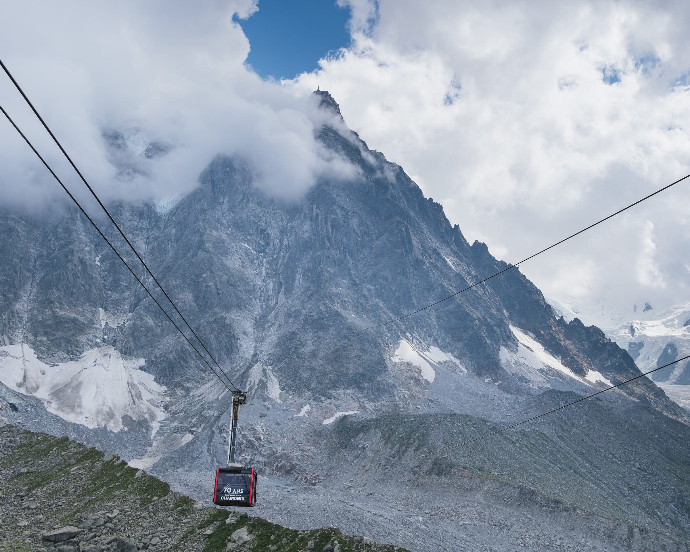 Cabine rouge du téléphérique de l'Aiguille du Midi sous le sommet, dans les nuages, Chamonix